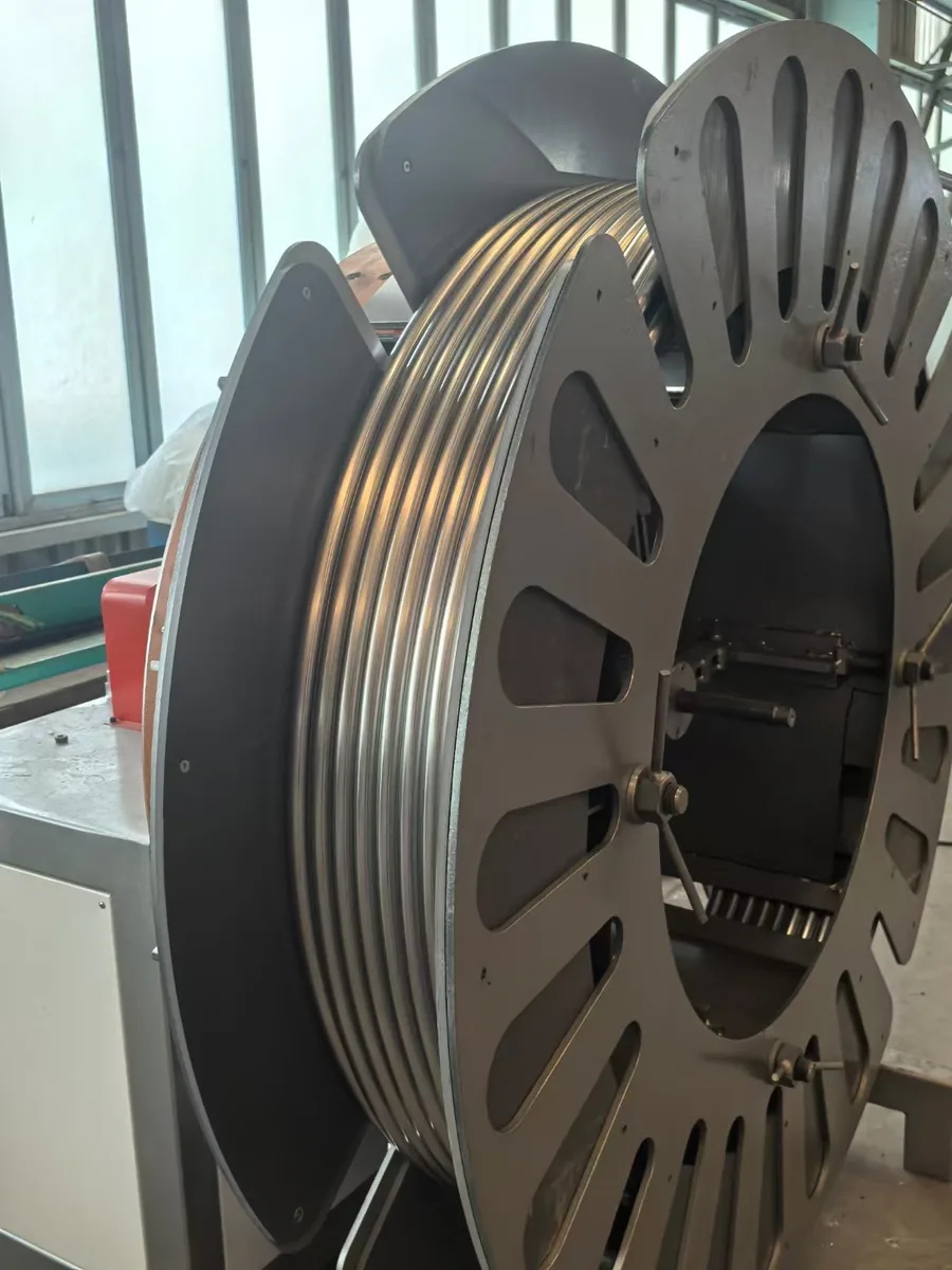 Coiled metal tube wound on a reel in the workshop